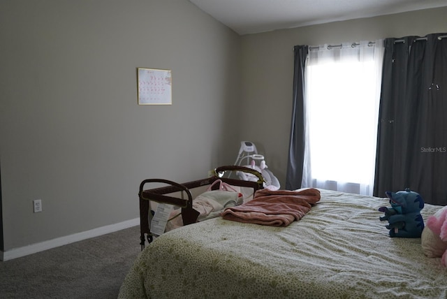 carpeted bedroom featuring multiple windows