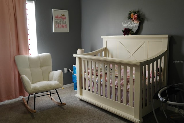 bedroom with carpet flooring and a nursery area