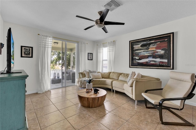 tiled living room featuring ceiling fan