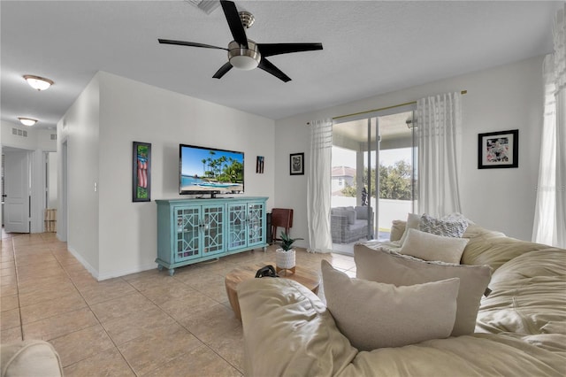 tiled living room featuring ceiling fan