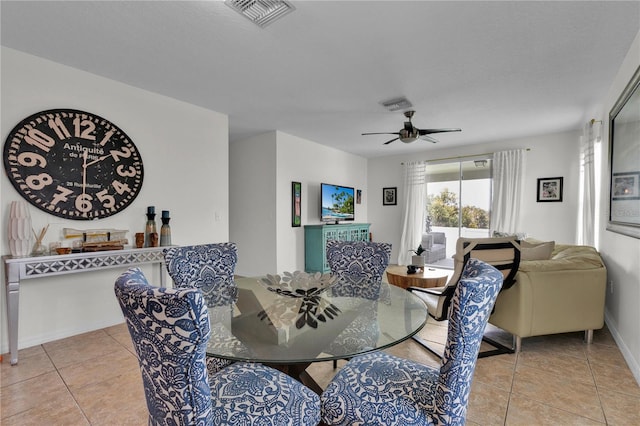 tiled dining area with ceiling fan