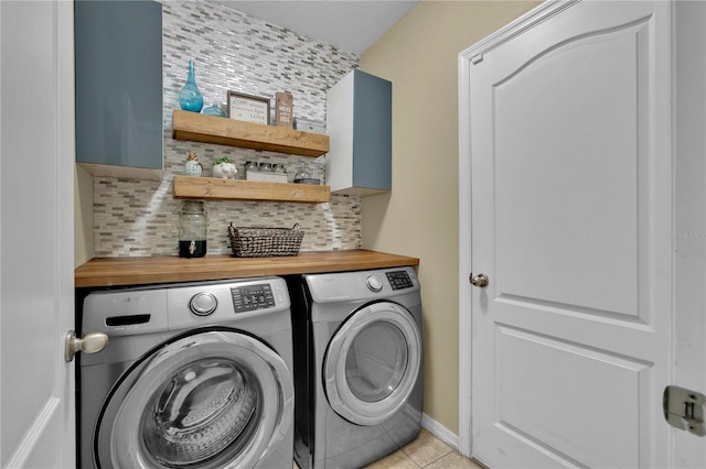 laundry room with separate washer and dryer and light tile floors