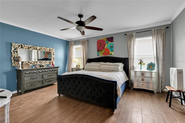 bedroom featuring ornamental molding, ceiling fan, and hardwood / wood-style floors