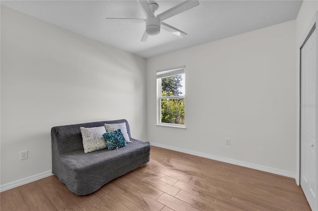 living area featuring ceiling fan and hardwood / wood-style floors