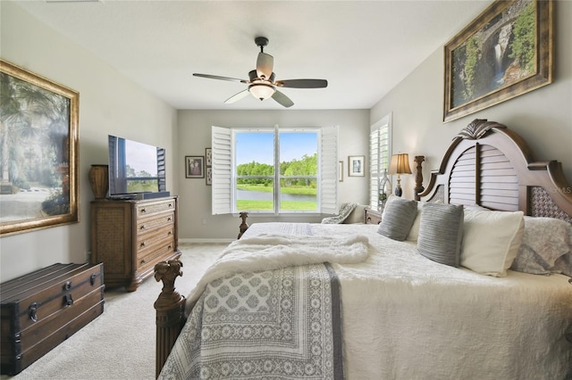 bedroom featuring light carpet and ceiling fan