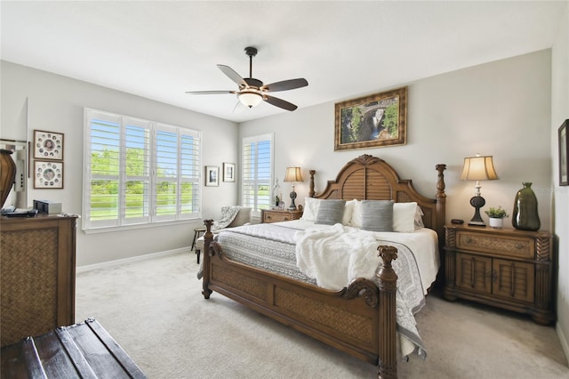 bedroom with ceiling fan and light carpet