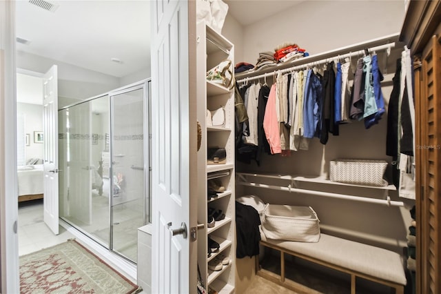 spacious closet with light tile patterned floors