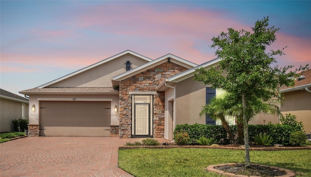 view of front of property with a lawn and a garage