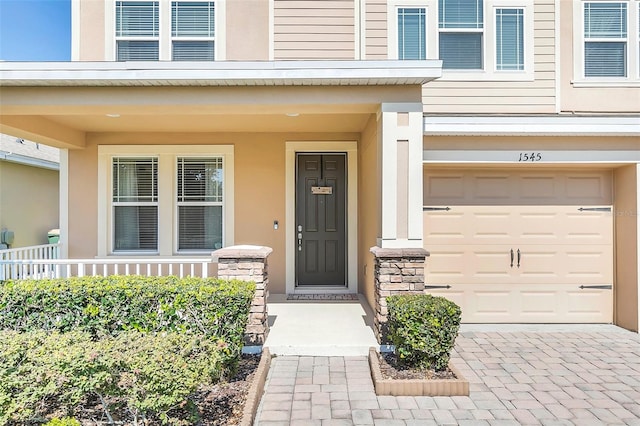 doorway to property with a garage