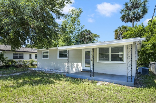 single story home featuring a front yard and central air condition unit