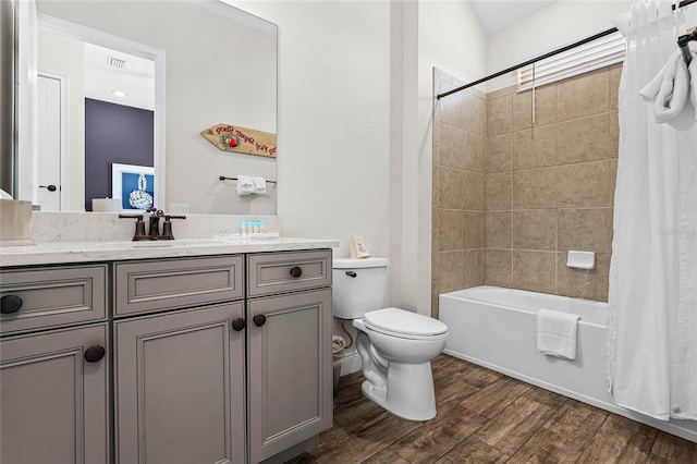 full bathroom featuring hardwood / wood-style floors, shower / tub combo, toilet, and vanity