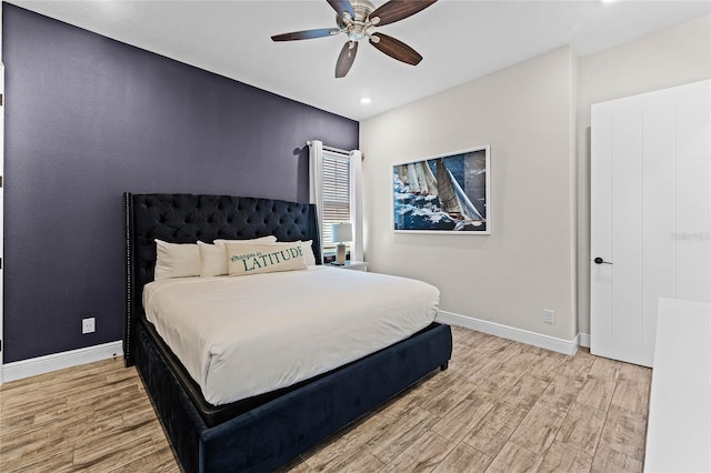 bedroom with ceiling fan and light wood-type flooring