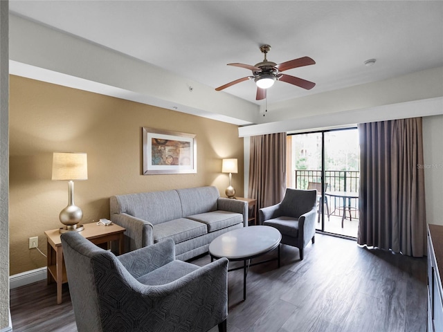 living room featuring ceiling fan and dark hardwood / wood-style flooring