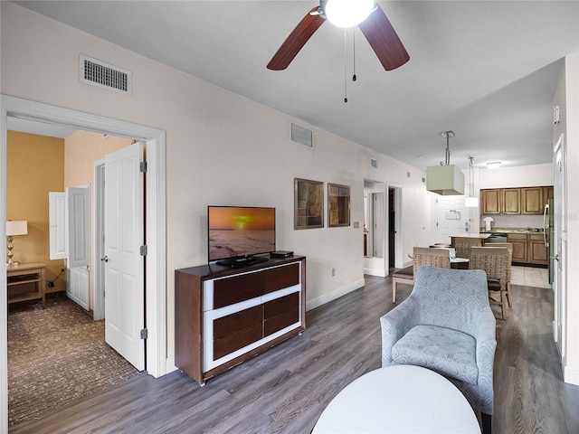 living room with ceiling fan and hardwood / wood-style flooring