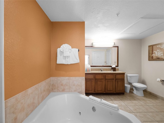 bathroom featuring tile flooring, a tub, a textured ceiling, toilet, and vanity