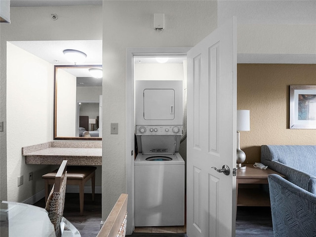 interior space with stacked washing maching and dryer