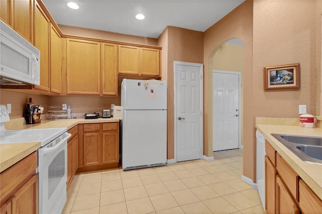 kitchen featuring sink, white appliances, and light tile patterned floors