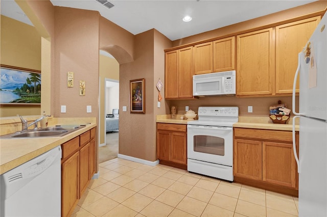 kitchen with sink, light tile patterned flooring, and white appliances