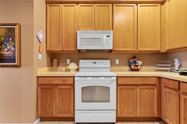 kitchen with light tile patterned flooring and white appliances