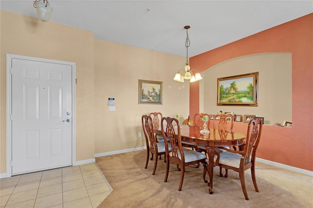 dining room with light tile patterned flooring and an inviting chandelier