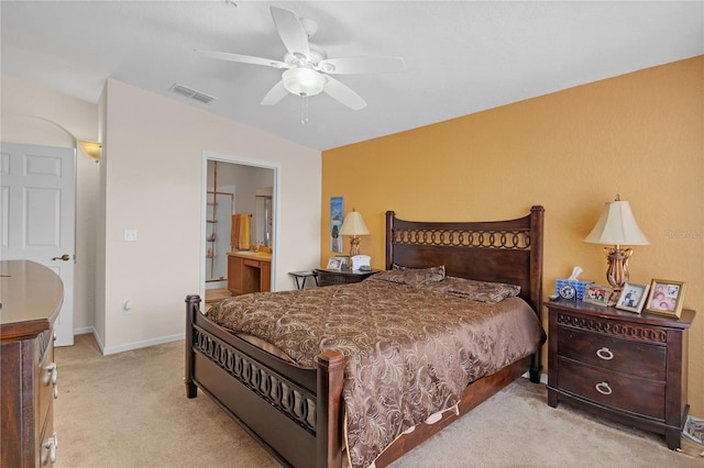 bedroom with light carpet, connected bathroom, and ceiling fan