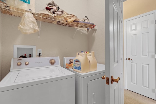 laundry area with light colored carpet and washing machine and dryer