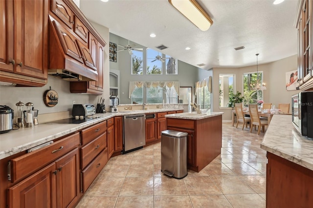 kitchen featuring decorative light fixtures, light tile flooring, a kitchen island, dishwasher, and ceiling fan