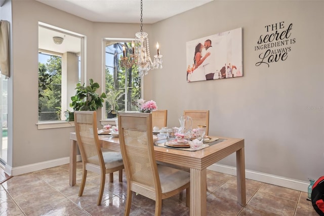 tiled dining space featuring an inviting chandelier