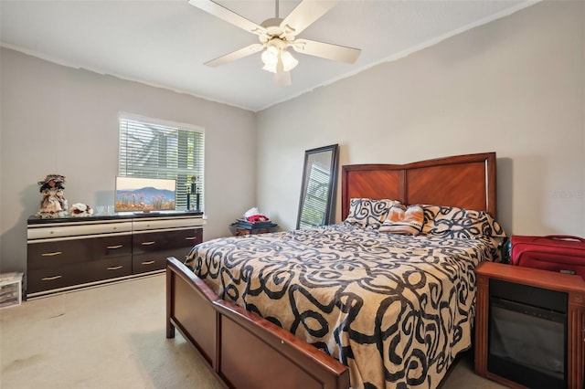 carpeted bedroom featuring ceiling fan and crown molding