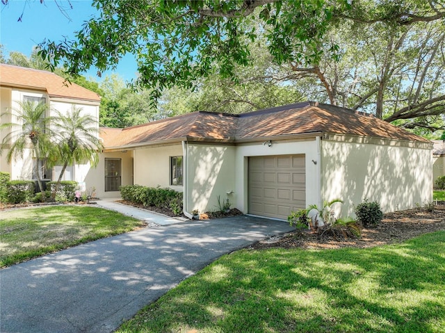 view of front of home with a garage and a front yard