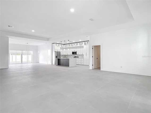 unfurnished living room with recessed lighting, visible vents, concrete flooring, and baseboards