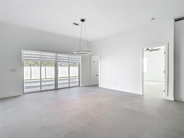 interior space featuring baseboards, visible vents, and concrete floors