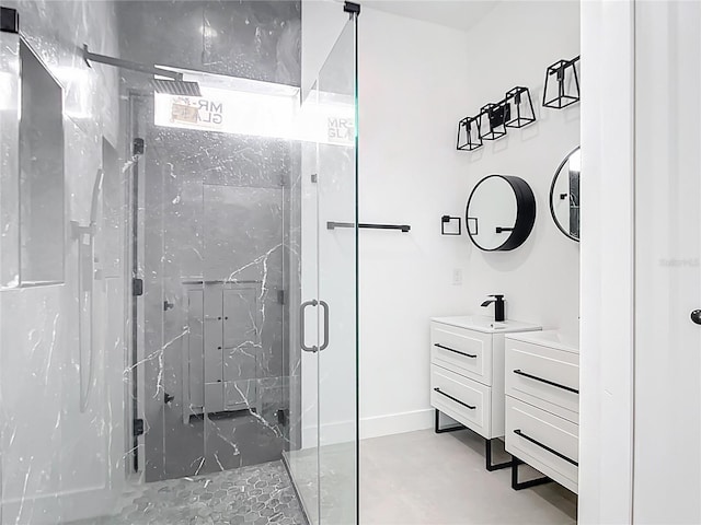 full bathroom featuring vanity and a marble finish shower