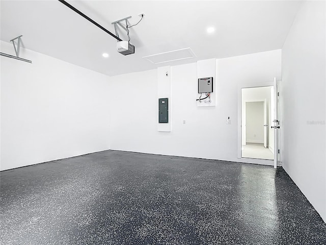 garage featuring electric panel and a garage door opener