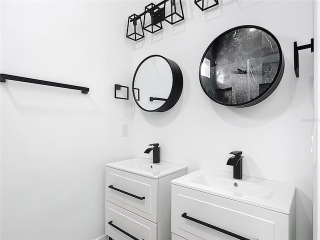 bathroom featuring two vanities and a sink