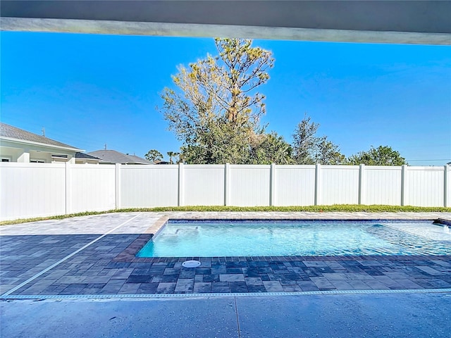 view of pool featuring a fenced in pool, a fenced backyard, and a patio area