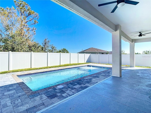 view of swimming pool featuring a fenced backyard, a fenced in pool, a patio, and a ceiling fan