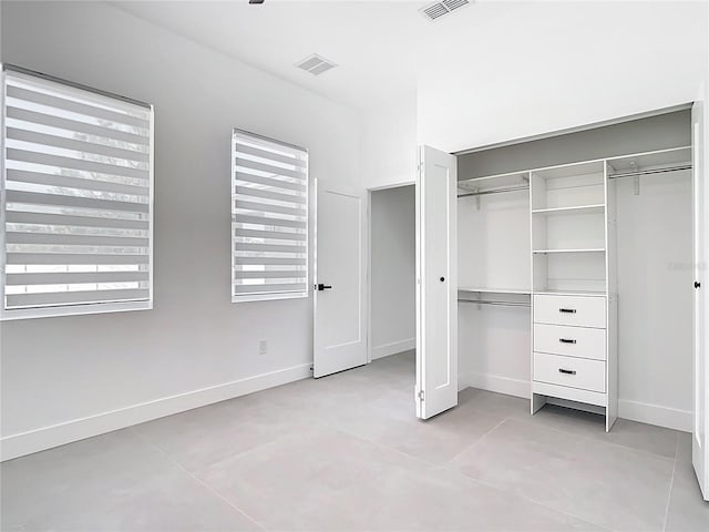 unfurnished bedroom featuring visible vents, baseboards, and a closet