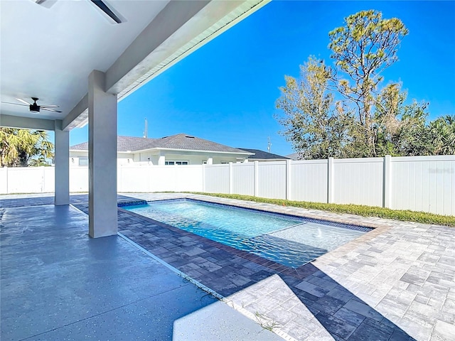 view of swimming pool featuring a fenced backyard, a fenced in pool, a patio, and ceiling fan