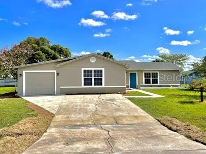 single story home featuring a garage and a front lawn