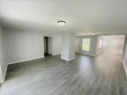 empty room with dark wood-type flooring