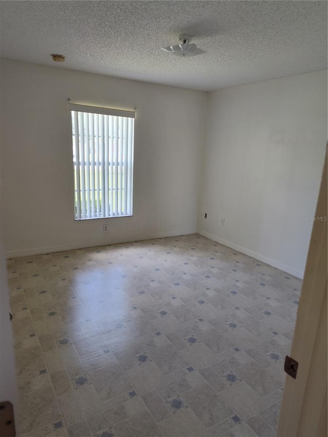 spare room with a textured ceiling