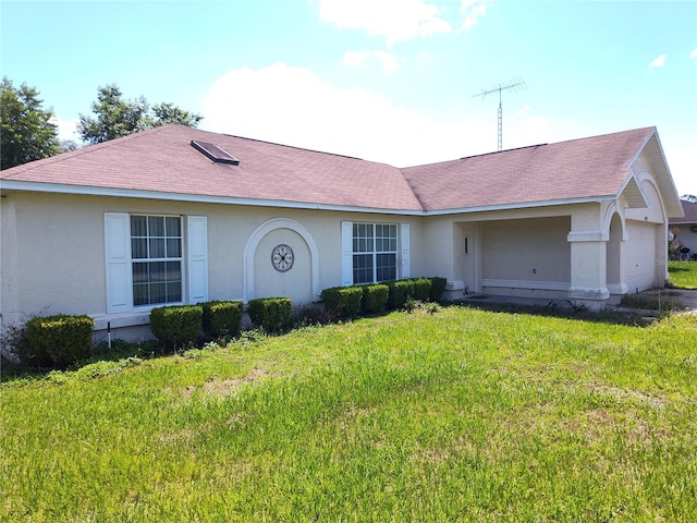 single story home featuring a front lawn and a garage