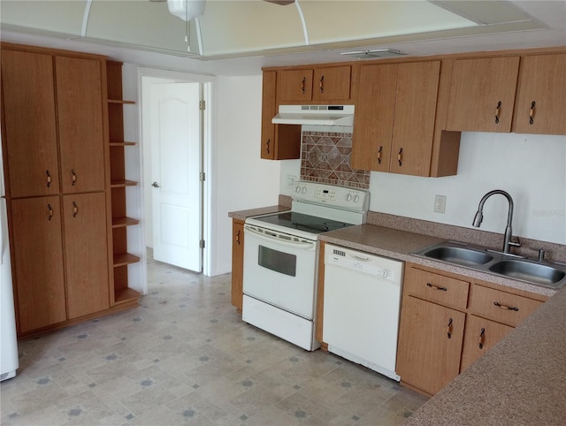 kitchen featuring white appliances, backsplash, and sink