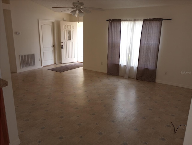 empty room with ceiling fan and lofted ceiling