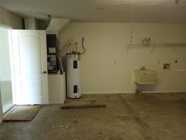 garage with heating unit, electric water heater, and sink