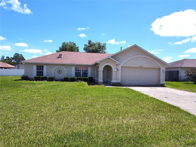 single story home featuring a garage and a front lawn