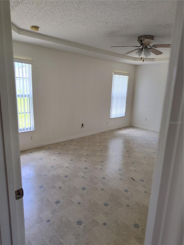 spare room with ceiling fan and a textured ceiling