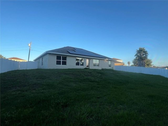 exterior space featuring a yard and solar panels