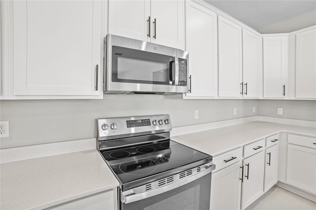 kitchen with white cabinets and appliances with stainless steel finishes